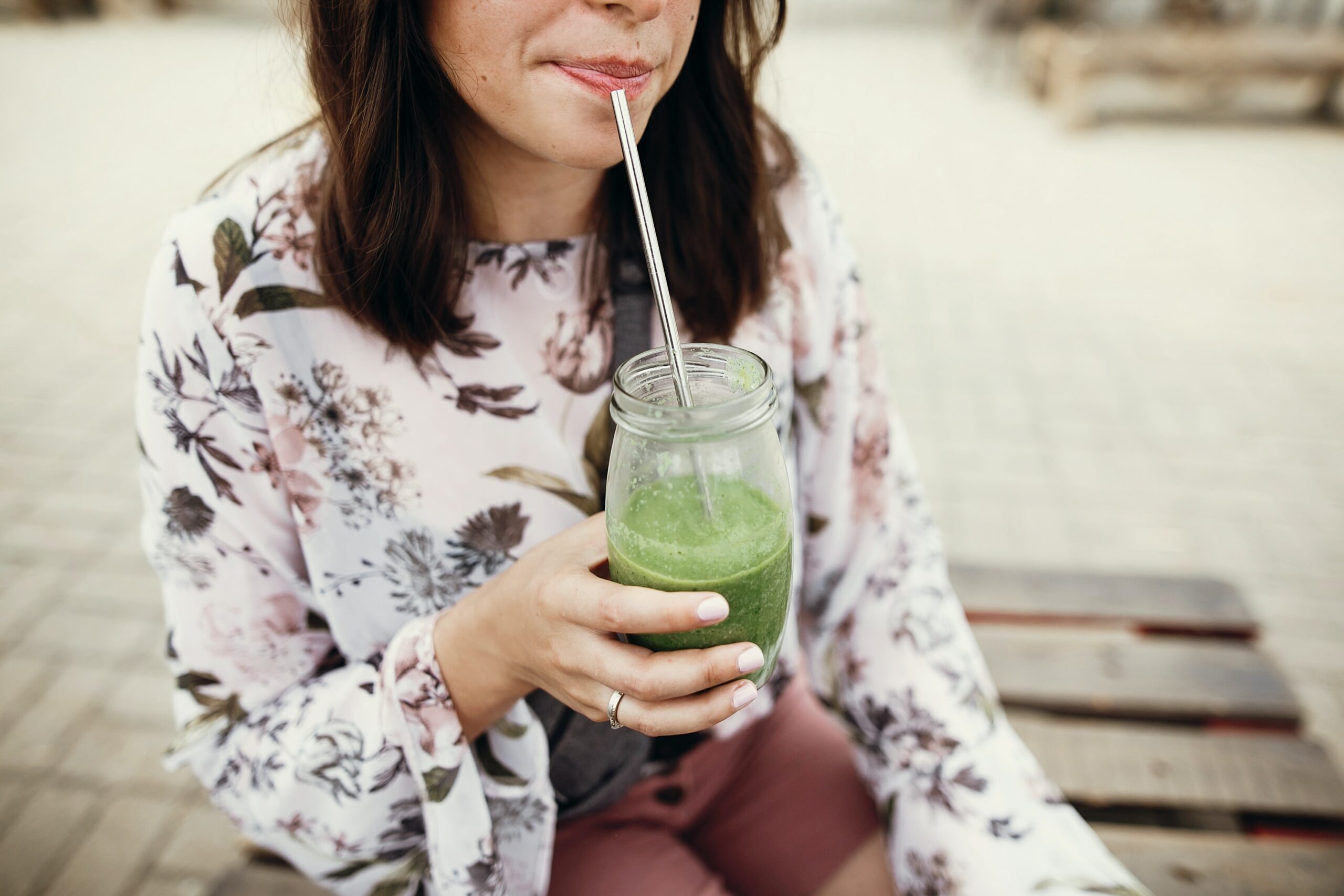woman drinking a glass of detox drink